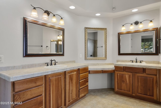 full bathroom featuring recessed lighting, two vanities, a sink, and tile patterned flooring