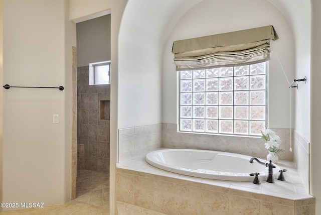 bathroom with walk in shower and a bath