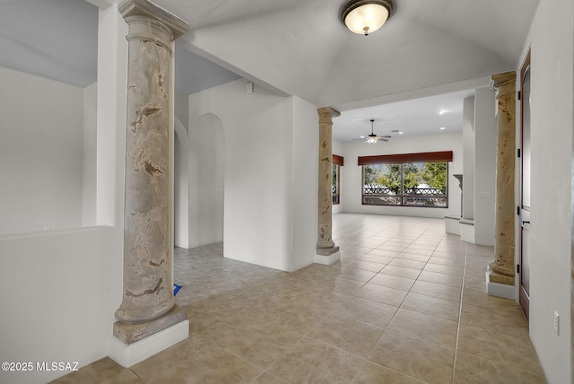 hallway featuring vaulted ceiling, tile patterned floors, and decorative columns