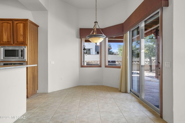 unfurnished dining area featuring light tile patterned flooring