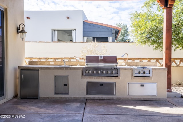 view of patio / terrace featuring an outdoor kitchen and grilling area