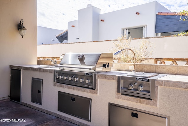 view of patio featuring a sink, a grill, and area for grilling