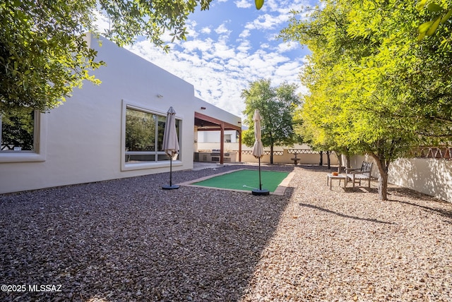 exterior space with a fenced backyard and a grill
