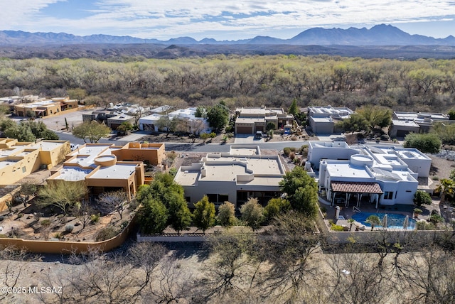 birds eye view of property with a view of trees, a residential view, and a mountain view