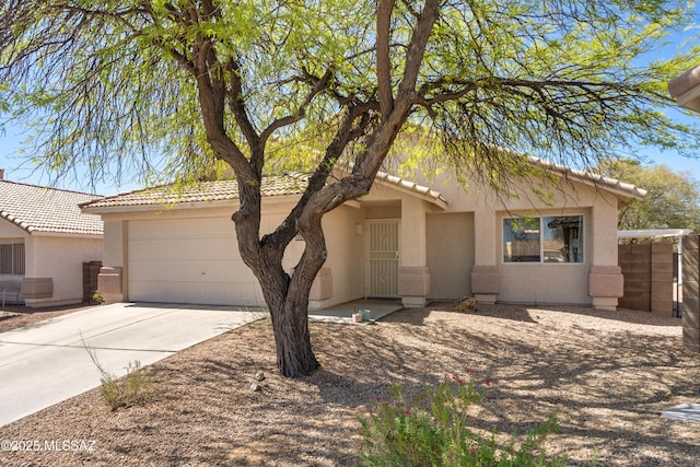 view of front facade featuring an attached garage, stucco siding, a tiled roof, and driveway