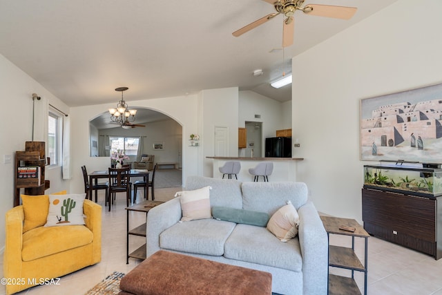 living room with light tile patterned floors, arched walkways, ceiling fan with notable chandelier, and lofted ceiling