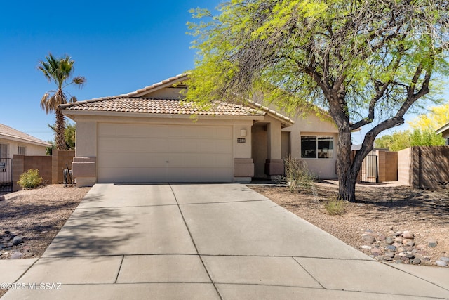 ranch-style home featuring fence, a tiled roof, concrete driveway, and stucco siding