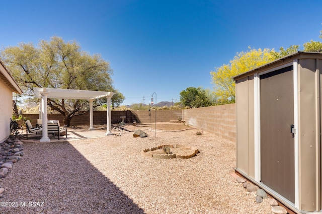 view of yard with an outdoor structure, a fenced backyard, and a patio area