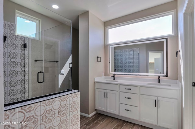 9290 N Jessy Ln, Tucson, AZ 85742 - bathroom with double vanity, a tile shower, wood finish floors, and a sink