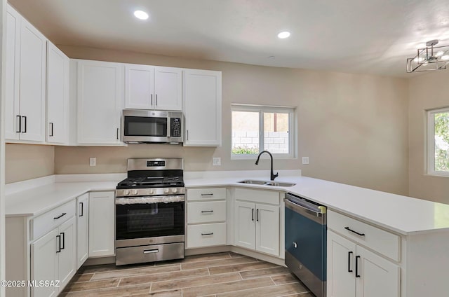 9290 N Jessy Ln, Tucson, AZ 85742 - kitchen featuring stainless steel appliances, white cabinets, a peninsula, and a sink