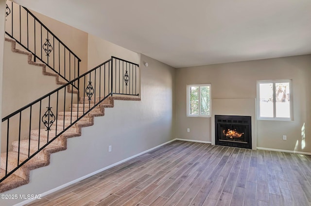 9290 N Jessy Ln, Tucson, AZ 85742 - unfurnished living room with wood finished floors, stairs, and baseboards