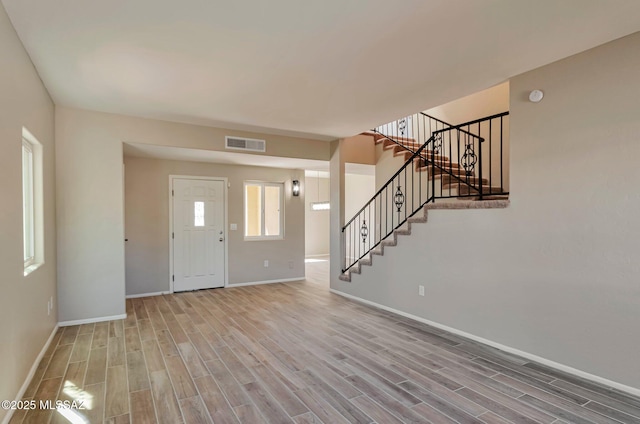 9290 N Jessy Ln, Tucson, AZ 85742 - entryway featuring wood finished floors, visible vents, and baseboards