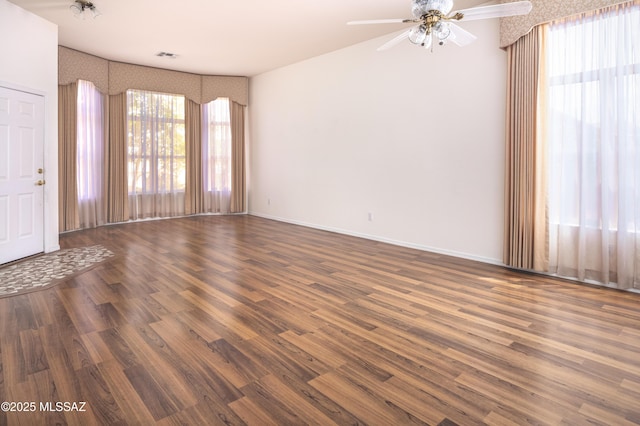 2377 W Catalina View Dr, Tucson, AZ 85742 - unfurnished room featuring wood finished floors, a ceiling fan, baseboards, and wallpapered walls