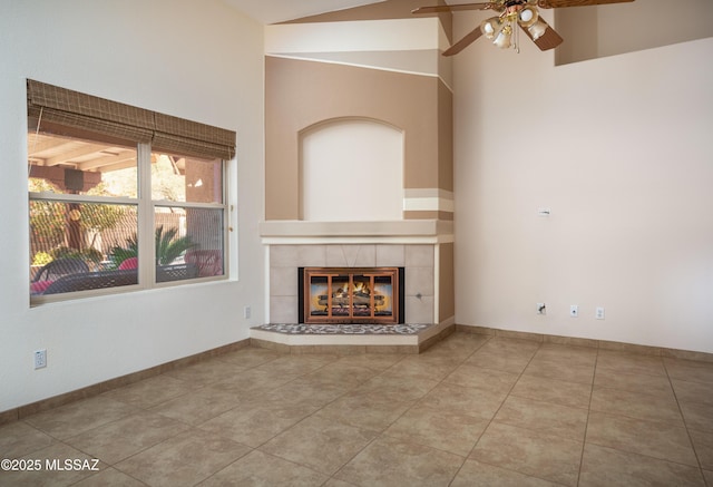 2377 W Catalina View Dr, Tucson, AZ 85742 - unfurnished living room with ceiling fan, a tiled fireplace, tile patterned floors, and lofted ceiling