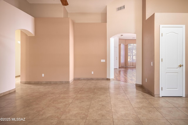2377 W Catalina View Dr, Tucson, AZ 85742 - spare room with arched walkways, a towering ceiling, and light tile patterned floors