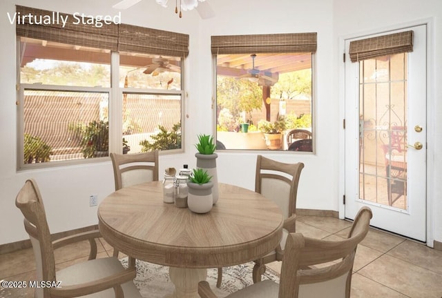 2377 W Catalina View Dr, Tucson, AZ 85742 - dining room featuring healthy amount of natural light, light tile patterned flooring, ceiling fan, and baseboards