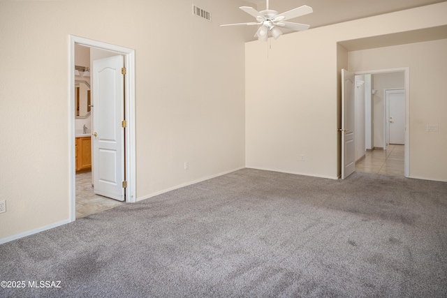 2377 W Catalina View Dr, Tucson, AZ 85742 - spare room featuring light carpet, a ceiling fan, and baseboards