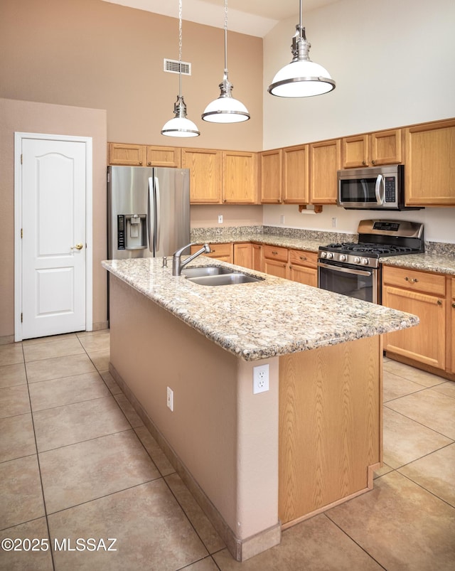 2377 W Catalina View Dr, Tucson, AZ 85742 - kitchen with stainless steel appliances, high vaulted ceiling, a sink, light tile patterned floors, and a center island with sink