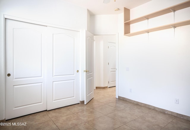 2377 W Catalina View Dr, Tucson, AZ 85742 - unfurnished bedroom with a closet, baseboards, and light tile patterned floors