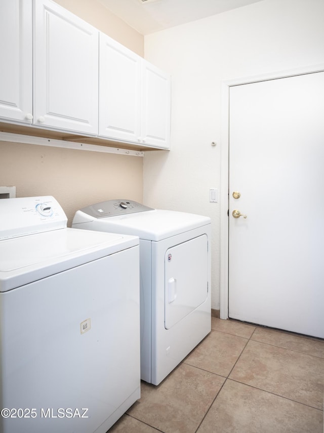 2377 W Catalina View Dr, Tucson, AZ 85742 - laundry area featuring washer and clothes dryer, cabinet space, and light tile patterned floors