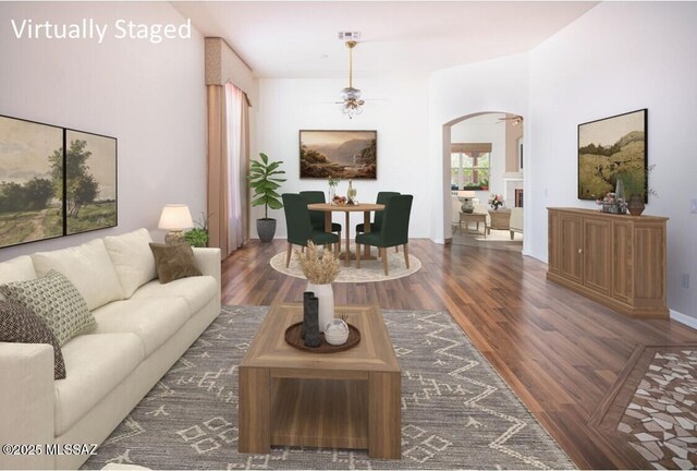 2377 W Catalina View Dr, Tucson, AZ 85742 - living room featuring arched walkways, a ceiling fan, and wood finished floors