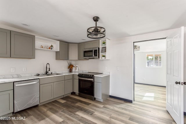 kitchen with gray cabinets, open shelves, and stainless steel appliances
