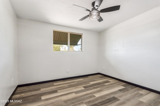 unfurnished room featuring baseboards, wood finished floors, and a ceiling fan