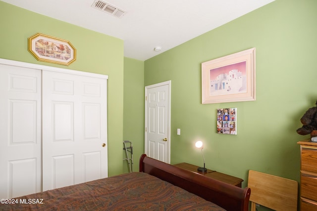 bedroom featuring visible vents and a closet