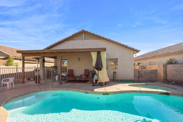 view of swimming pool with fence, a patio area, an in ground hot tub, and a fenced in pool