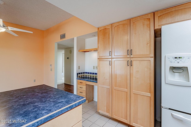 2778 S Via Del Bac, Green Valley, AZ 85622 - kitchen with light tile patterned floors, white fridge with ice dispenser, light brown cabinetry, and visible vents