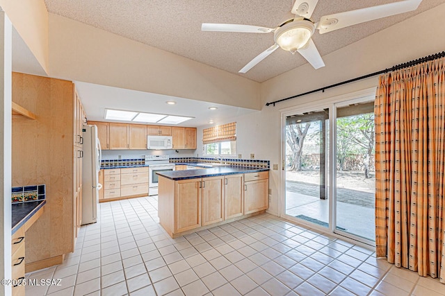 2778 S Via Del Bac, Green Valley, AZ 85622 - kitchen featuring dark countertops, light brown cabinetry, light tile patterned flooring, a wealth of natural light, and white appliances