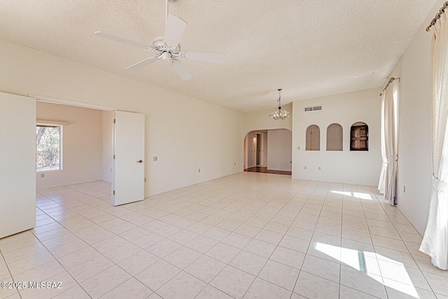 2778 S Via Del Bac, Green Valley, AZ 85622 - spare room with light tile patterned floors, a textured ceiling, visible vents, and arched walkways