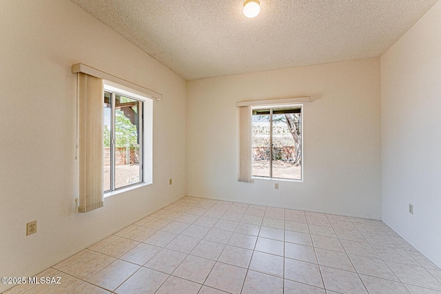 2778 S Via Del Bac, Green Valley, AZ 85622 - spare room featuring light tile patterned flooring, a textured ceiling, and a healthy amount of sunlight