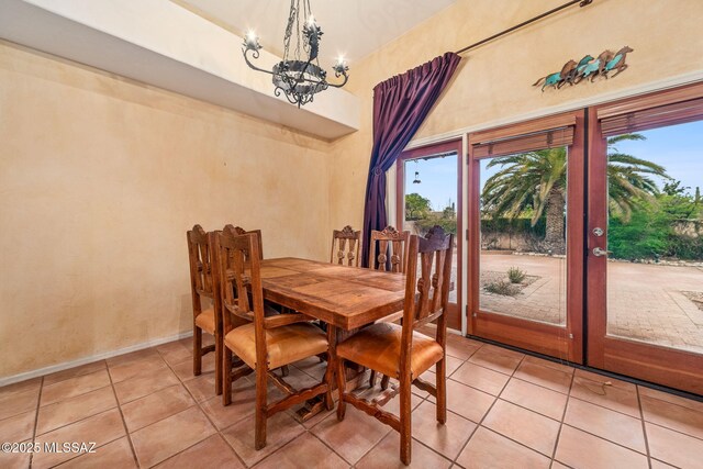 550 E Squirrel Tail Dr, Tucson, AZ 85704 - dining room featuring a chandelier, french doors, light tile patterned floors, and a high ceiling