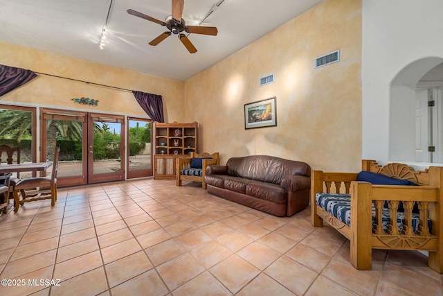 550 E Squirrel Tail Dr, Tucson, AZ 85704 - living area with track lighting, arched walkways, a ceiling fan, and light tile patterned floors