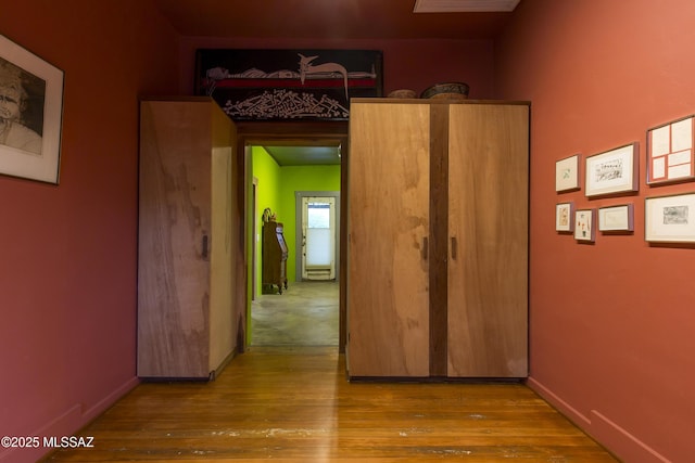 interior space with baseboards and wood finished floors