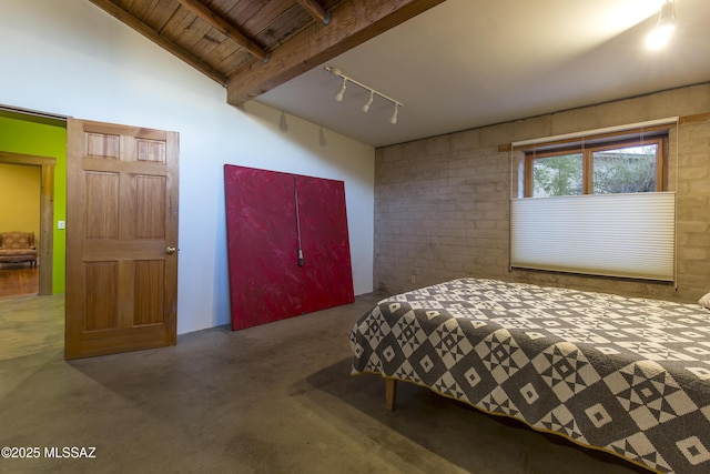 bedroom with beamed ceiling, rail lighting, and wood ceiling