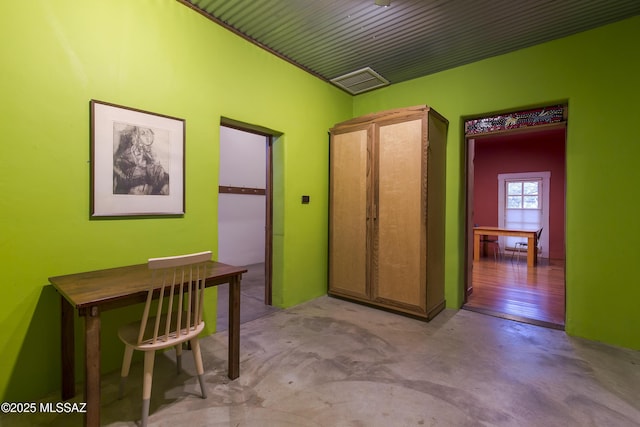 interior space featuring visible vents and concrete floors