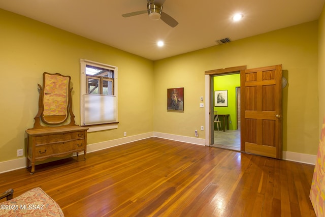 interior space featuring recessed lighting, ceiling fan, visible vents, baseboards, and hardwood / wood-style flooring