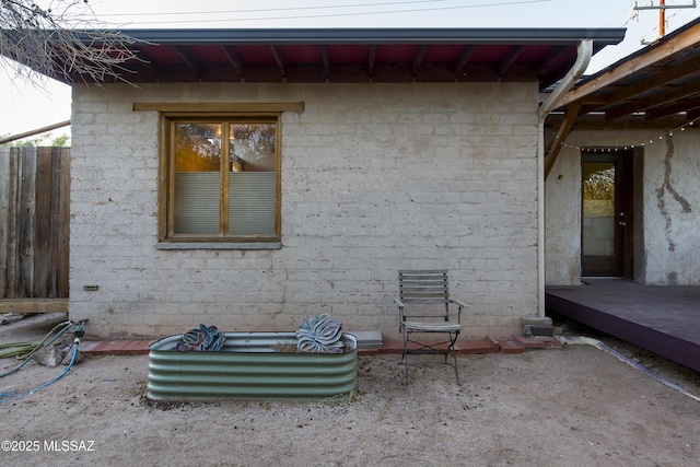 view of side of home featuring fence