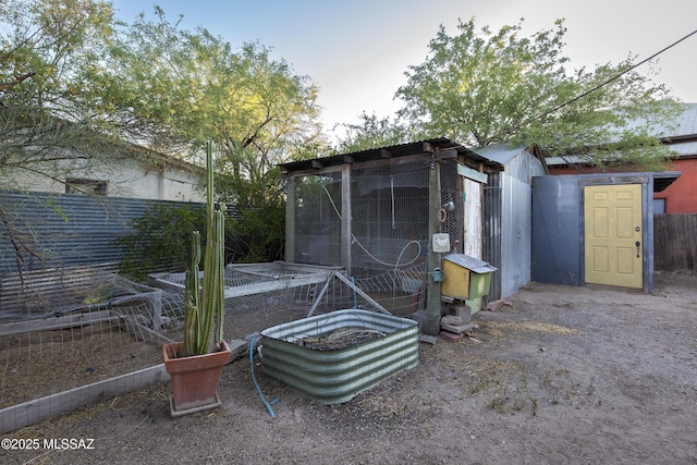 view of poultry coop featuring fence