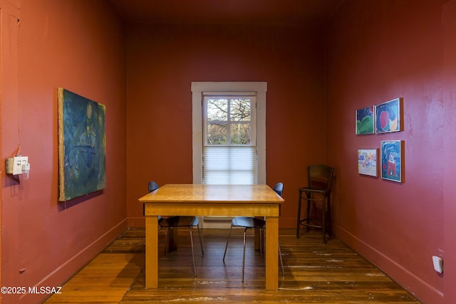 dining area featuring wood finished floors and baseboards