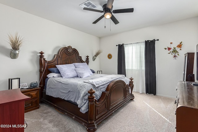 bedroom with visible vents, ceiling fan, light carpet, and baseboards