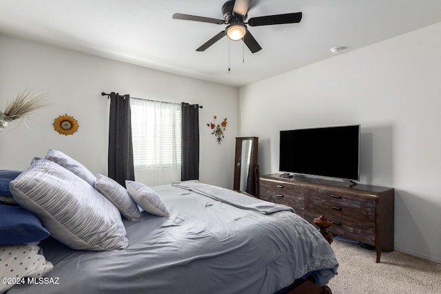 bedroom with ceiling fan and light carpet