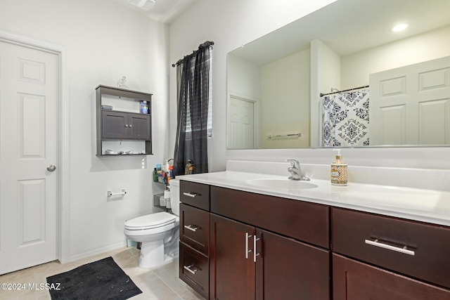 bathroom featuring toilet, tile patterned flooring, and vanity
