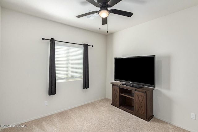 unfurnished living room featuring a ceiling fan, carpet flooring, and baseboards