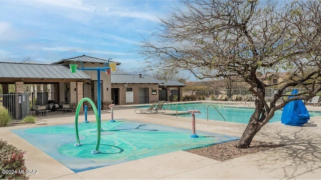 pool with a patio area and fence