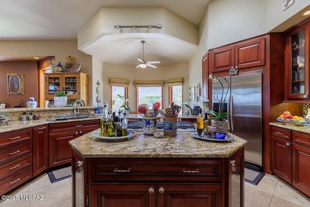 5310 N Calle Bujia, Tucson, AZ 85718 - kitchen with stainless steel refrigerator with ice dispenser, reddish brown cabinets, a sink, and a ceiling fan
