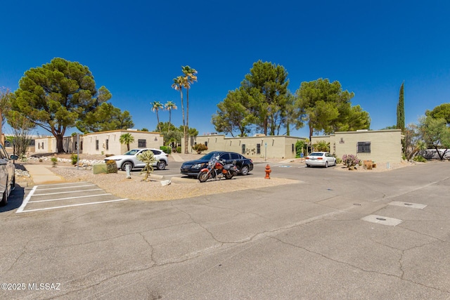 uncovered parking lot with a residential view