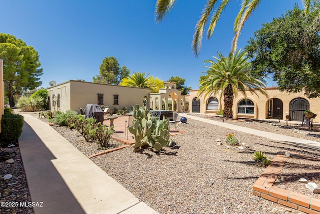 exterior space featuring stucco siding and a patio area